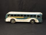 a toy bus that is sitting on a black surface