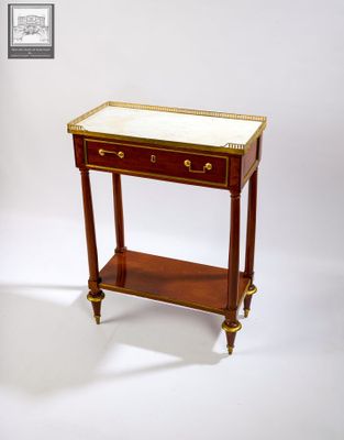 a small wooden table with a marble top on it