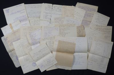 many papers are stacked on top of each other on a table