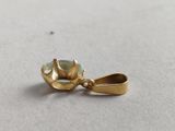 an image of a close up of a gold plated object on a table