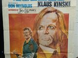 movie poster of a man holding a gun in front of a poster of a man