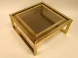 a glass table with a gold frame on it