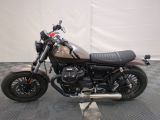 a picture of a motorcycle that is parked on a checkered floor