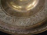 a close up of a metal plate with a design on it