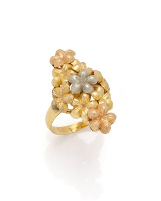 a close up of a gold and silver ring on a white surface