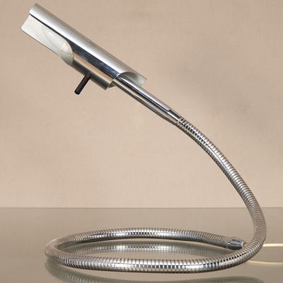 an image of a chrome plated faucet with a hose attached to it