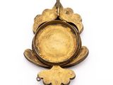 an image of a gold plate with a flower on it