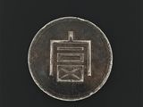 un gros plan d'une pièce d'argent sur laquelle figure une inscription en chinois