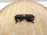 a pair of sunglasses sitting on top of a woven basket