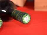 two bottles of wine sitting on a red table