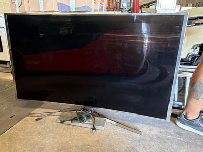 a man standing in front of a flat screen tv
