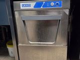 stainless steel dishwasher in a commercial kitchen with blue tiles