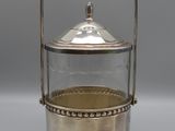 an antique silver plated teapot with a glass lid