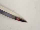 a knife that is laying on a table