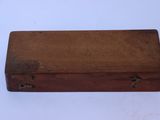 an old wooden box sitting on top of a white table