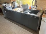 a kitchen with a sink, dishwasher, and a dishwasher