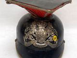 un casque noir orné d'un motif rouge et or