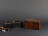 two small wooden boxes sitting next to each other on a gray surface