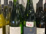 Des bouteilles de vin sont alignées sur le comptoir d'un caviste.