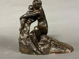 an image of a bronze statue of a woman hugging a child