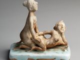 figurine of a woman and a child on a marble base