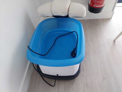 un bac à pieds bleu et blanc posé sur un parquet