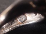a close up of a silver object on a black surface