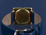 an image of a close up of a watch on a blue surface