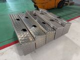 a stack of metal boxes sitting on the floor in a warehouse
