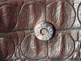 a close up of a leather wallet with a button on it