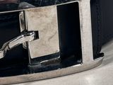 a close up of a black belt with a silver buckle