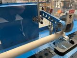 a machine that is working on a piece of wood