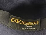 grey fedora hat with black band and logo on the side