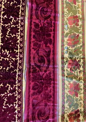 three pieces of purple and green fabric with floral designs on them