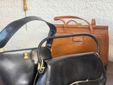 two bags sitting on a table next to each other