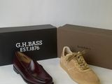 two pairs of men ' s shoes sitting next to a box of shoes
