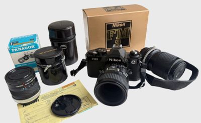 a camera, lens, camera case, and other items on the table