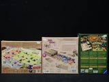 three boxes of games sitting on a black surface