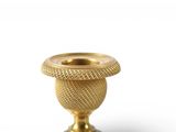a gold candle holder on a white background