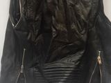 black leather jacket on a hanger on a white background