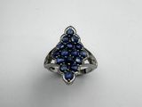 a close up of a ring with blue stones on it