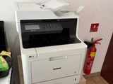 a printer sitting on top of a filing cabinet next to a computer