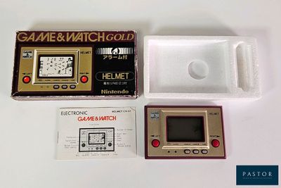 a game and watch gold box with a game in it