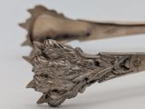 pair of antique silverware spoons with a lion head on the handle