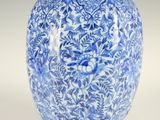 a blue and white vase with a floral design on it