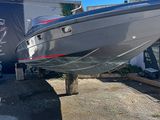 a boat that is sitting on the ground in a lot