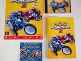 three books on a table with a motorcycle on the cover