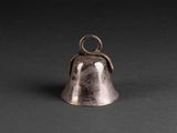 a silver bell with a snake on top of it on a black background