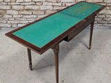 an image of a table with a green top and a wooden legs