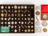 a box full of silver and gold coins on a white surface